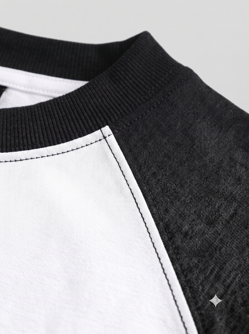 Lucsum Raglan white oversized tee with charcoal sleeves and collar, macro raglan seam and ribbed collar detail