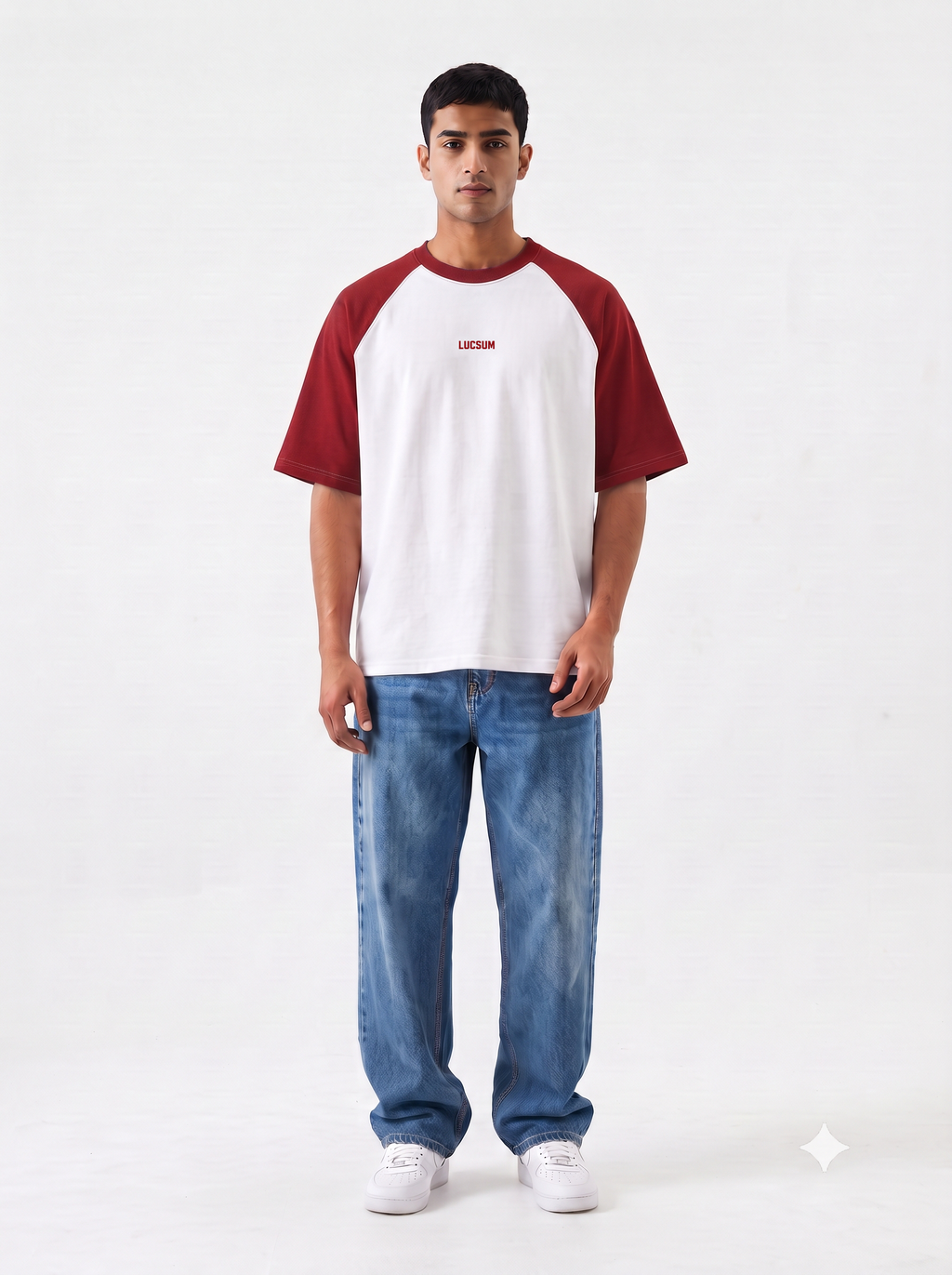 Model wearing the Lucsum Raglan white oversized tee with crimson sleeves and baggy jeans, full-length front view
