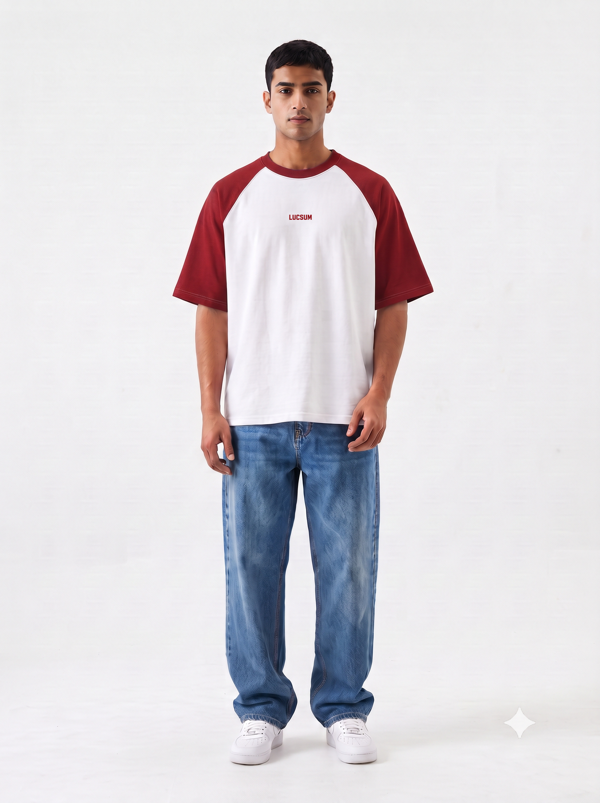 Model wearing the Lucsum Raglan white oversized tee with crimson sleeves and baggy jeans, full-length front view
