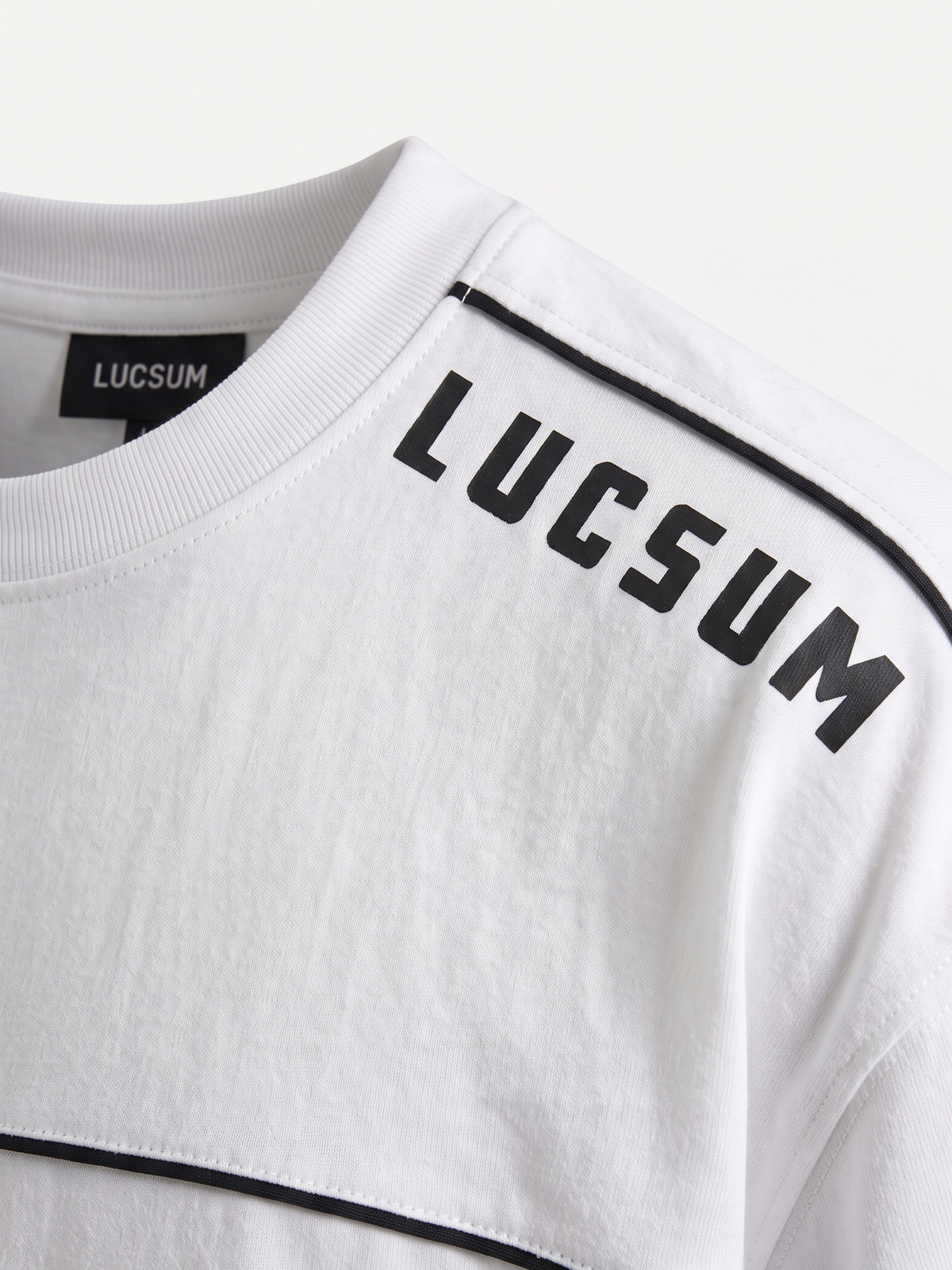 Lucsum Shoulder Logo White — Macro close-up
